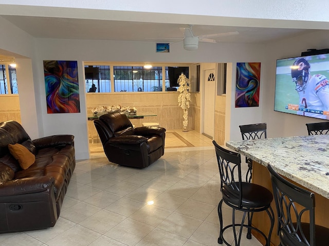 tiled living room featuring ceiling fan