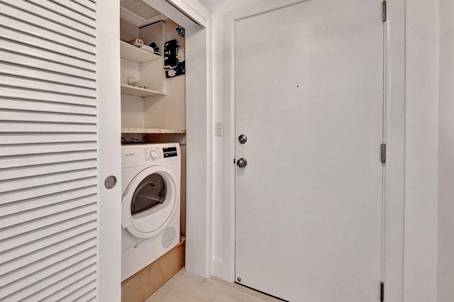 clothes washing area featuring washer / clothes dryer