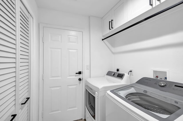 clothes washing area featuring independent washer and dryer, washer hookup, electric dryer hookup, and cabinets