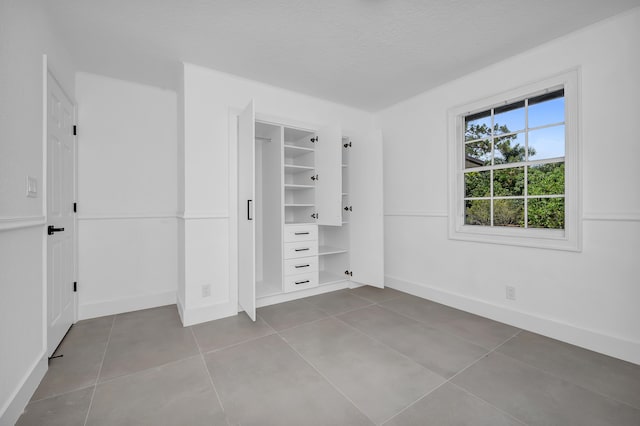 unfurnished bedroom featuring tile floors