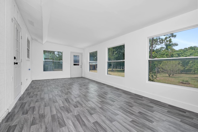 unfurnished sunroom featuring lofted ceiling