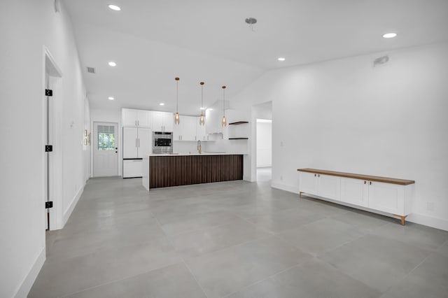 kitchen featuring paneled fridge, a kitchen island, light tile flooring, and pendant lighting