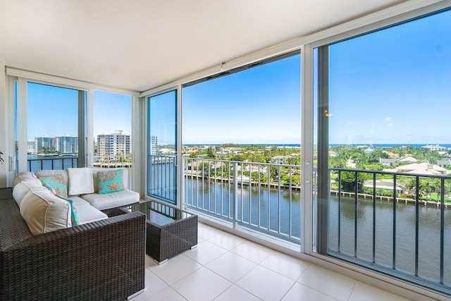 sunroom / solarium with a water view and plenty of natural light