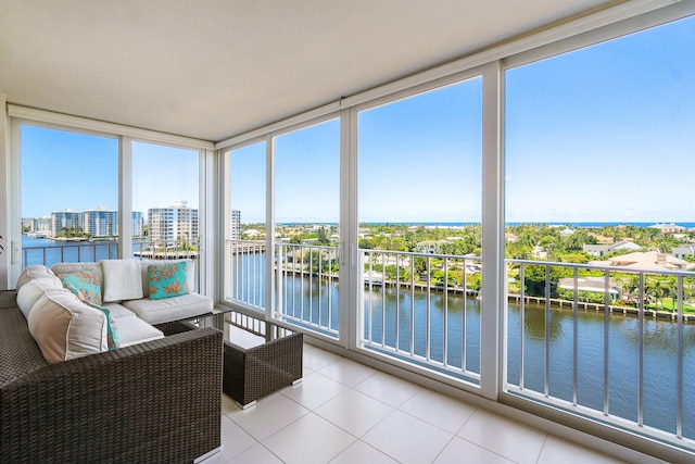 sunroom with a water view and a wealth of natural light