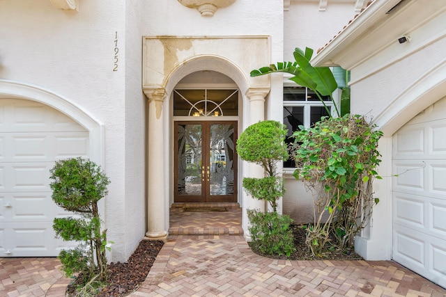 doorway to property featuring a garage and french doors