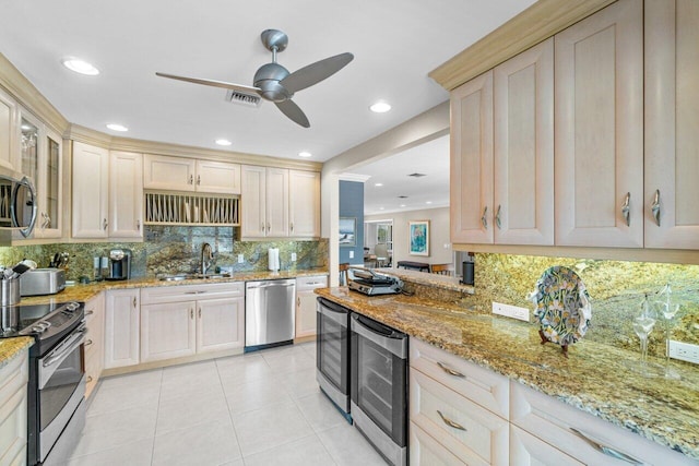 kitchen featuring decorative backsplash, beverage cooler, ceiling fan, appliances with stainless steel finishes, and sink