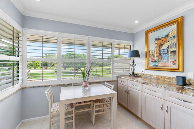 dining area featuring crown molding, light tile patterned floors, and plenty of natural light