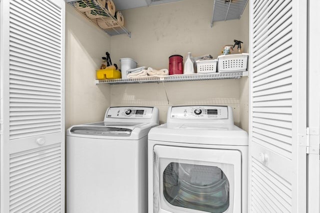 clothes washing area with washing machine and clothes dryer