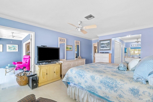 bedroom with a textured ceiling, a closet, ceiling fan, crown molding, and light tile patterned floors