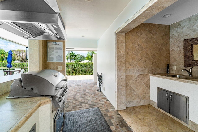 view of patio / terrace featuring exterior kitchen, sink, and a grill