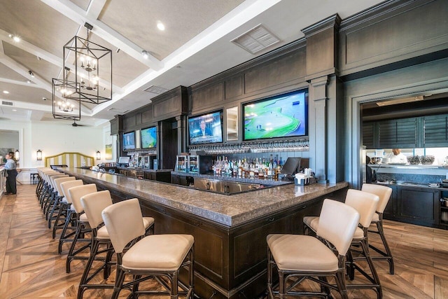 bar featuring a chandelier, beamed ceiling, pendant lighting, light parquet floors, and coffered ceiling