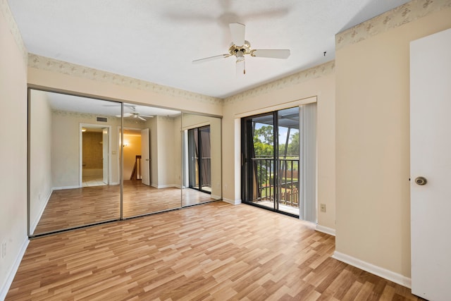 unfurnished bedroom with ceiling fan, a closet, light wood-type flooring, and access to exterior