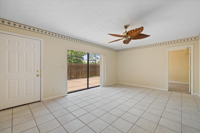 empty room with ceiling fan and light tile flooring