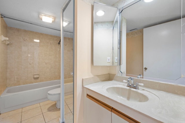 full bathroom featuring tile flooring, a textured ceiling, tiled shower / bath, large vanity, and toilet