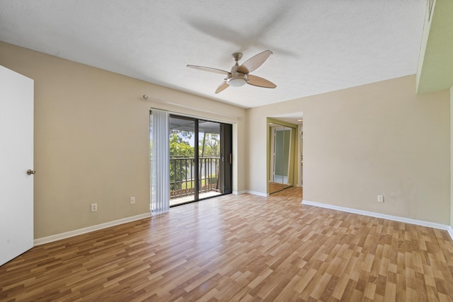 spare room with ceiling fan, a textured ceiling, and light wood-type flooring