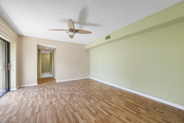 spare room featuring a textured ceiling, ceiling fan, and light hardwood / wood-style flooring