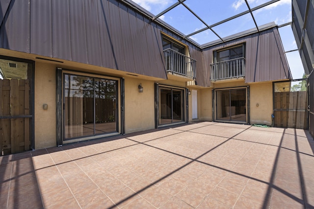 rear view of house with a patio area, a balcony, and a lanai