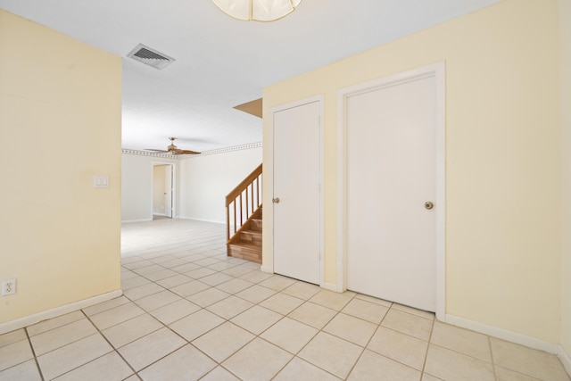 tiled spare room featuring ceiling fan