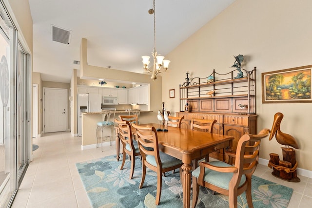 dining area featuring a notable chandelier, high vaulted ceiling, and light tile flooring