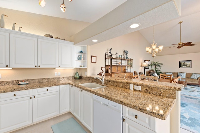 kitchen with ceiling fan with notable chandelier, white dishwasher, sink, lofted ceiling, and white cabinetry