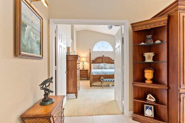 bedroom with lofted ceiling and light colored carpet