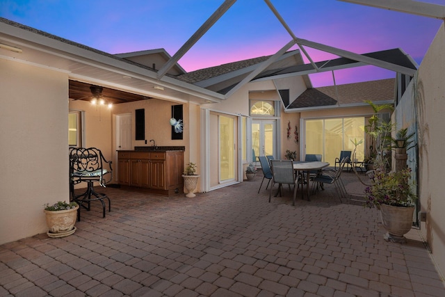 patio terrace at dusk with sink and glass enclosure