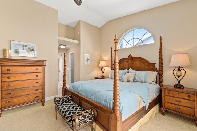 bedroom with light colored carpet, vaulted ceiling, and ensuite bathroom