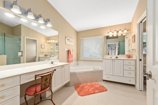 bathroom featuring shower with separate bathtub, vaulted ceiling, tile floors, and large vanity