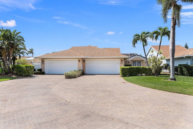 view of front of property featuring a garage and a front lawn