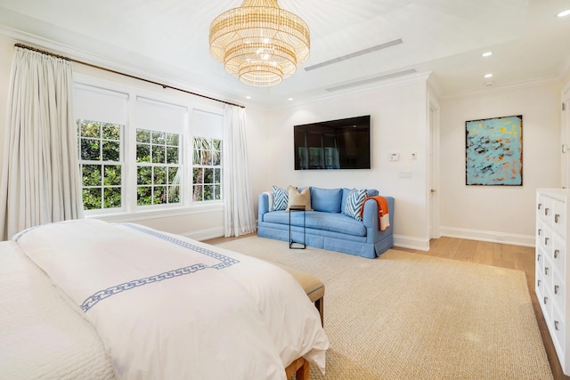 bedroom with light wood-type flooring, crown molding, and a notable chandelier