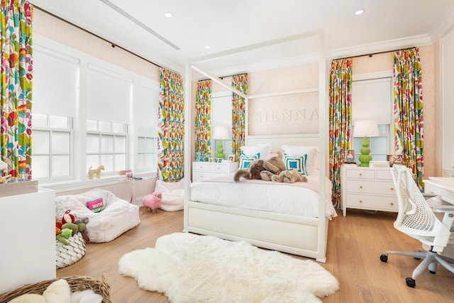 bedroom featuring light hardwood / wood-style floors and crown molding