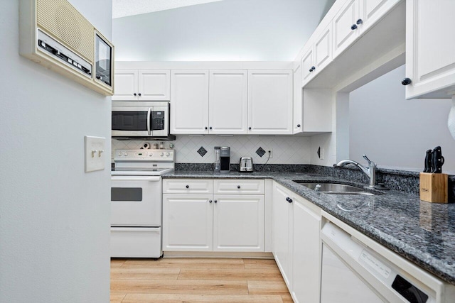 kitchen with decorative backsplash, light hardwood / wood-style floors, white cabinetry, white appliances, and sink