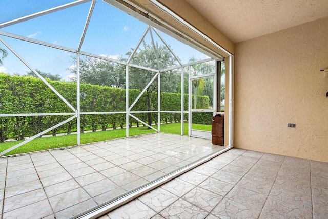 unfurnished sunroom featuring vaulted ceiling