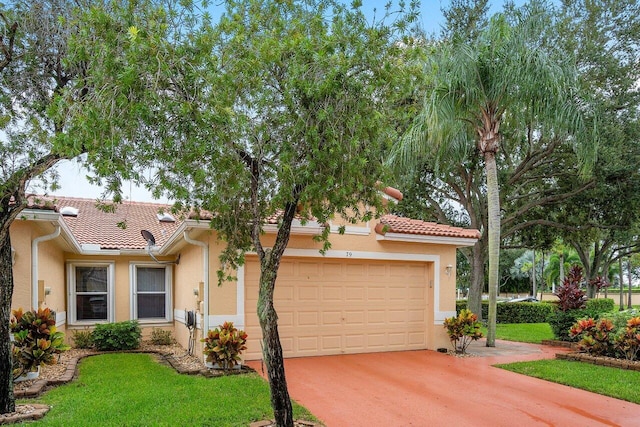 view of front of property featuring a front yard and a garage