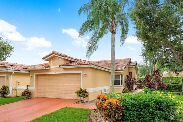 mediterranean / spanish home with a garage