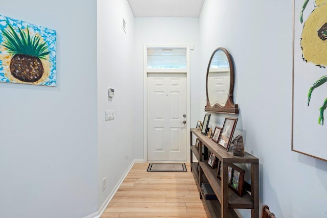 doorway to outside with light wood-type flooring