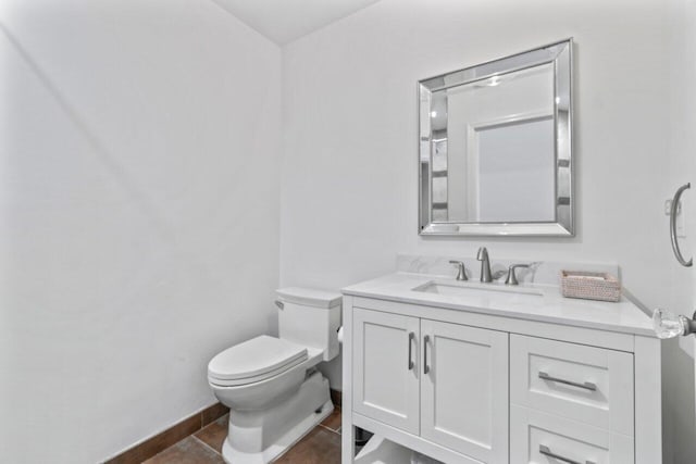 bathroom with tile patterned floors, vanity, and toilet