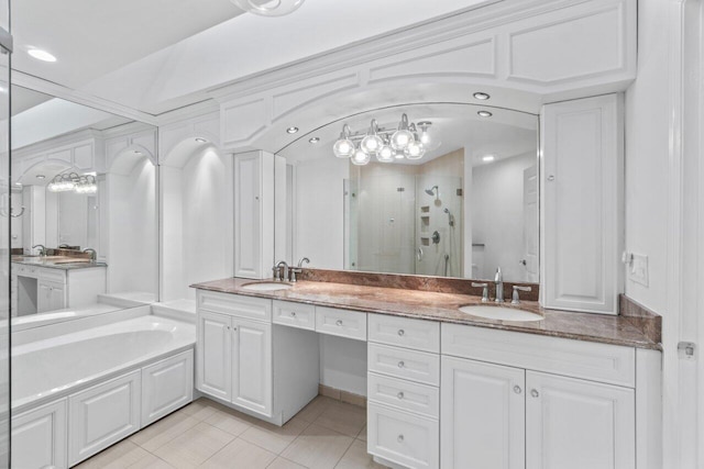 bathroom with plus walk in shower, vanity, and tile patterned flooring