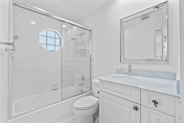 full bathroom featuring vanity, toilet, and bath / shower combo with glass door