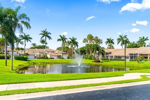 view of community featuring a lawn and a water view