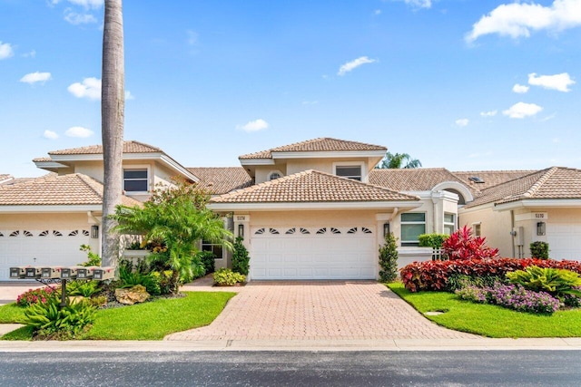 mediterranean / spanish home featuring a garage