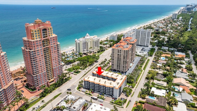 aerial view with a water view and a beach view