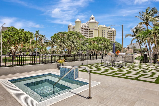 view of pool with an in ground hot tub