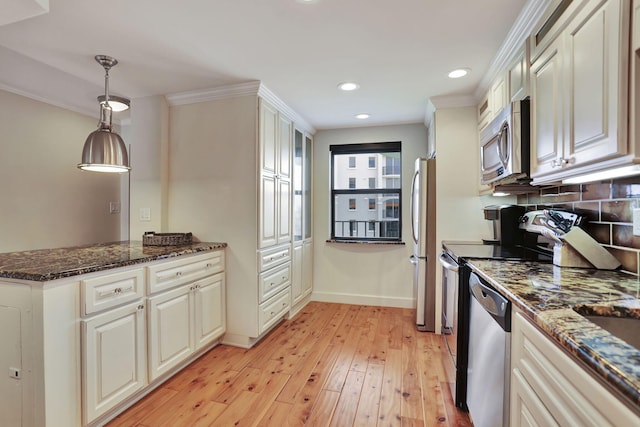 kitchen featuring decorative backsplash, appliances with stainless steel finishes, light wood-type flooring, crown molding, and pendant lighting