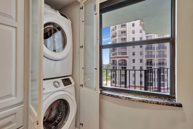 clothes washing area featuring stacked washer / drying machine