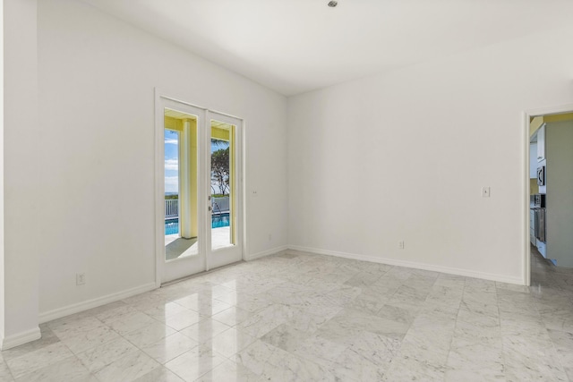 empty room featuring baseboards and marble finish floor