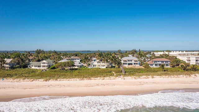 aerial view with a residential view, a beach view, and a water view