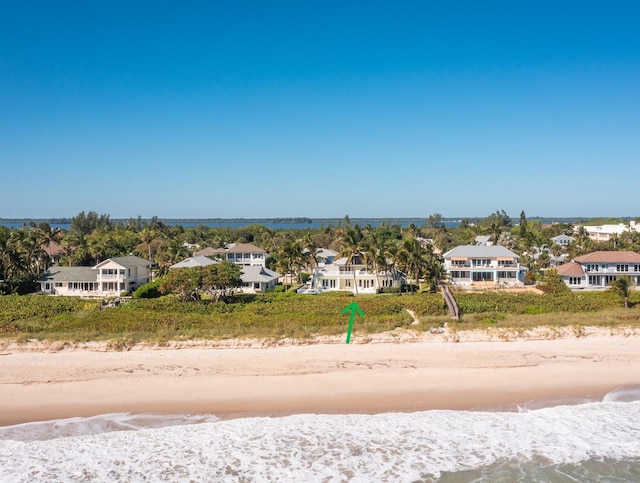 birds eye view of property featuring a residential view, a beach view, and a water view