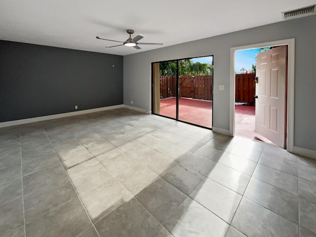 tiled spare room featuring ceiling fan