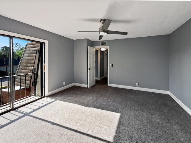 unfurnished bedroom with ceiling fan and dark carpet